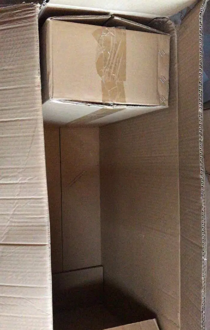 Inner carton placed inside an outer carton in a selected clock spring packing program